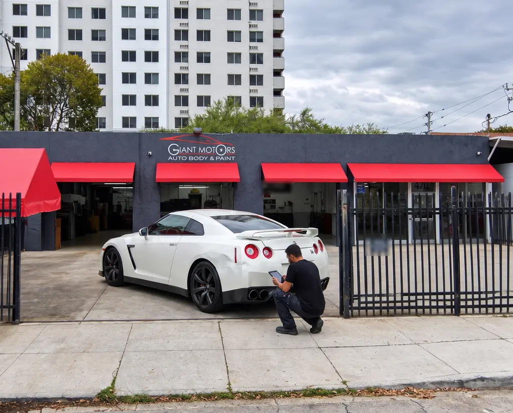 A Giant Motors estimator inspecting the GT-R’s rear quarter panel
